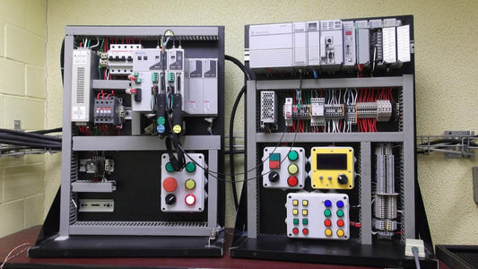 Two industrial control panels sit side by side on a table, part of an Allen-Bradley automation system.