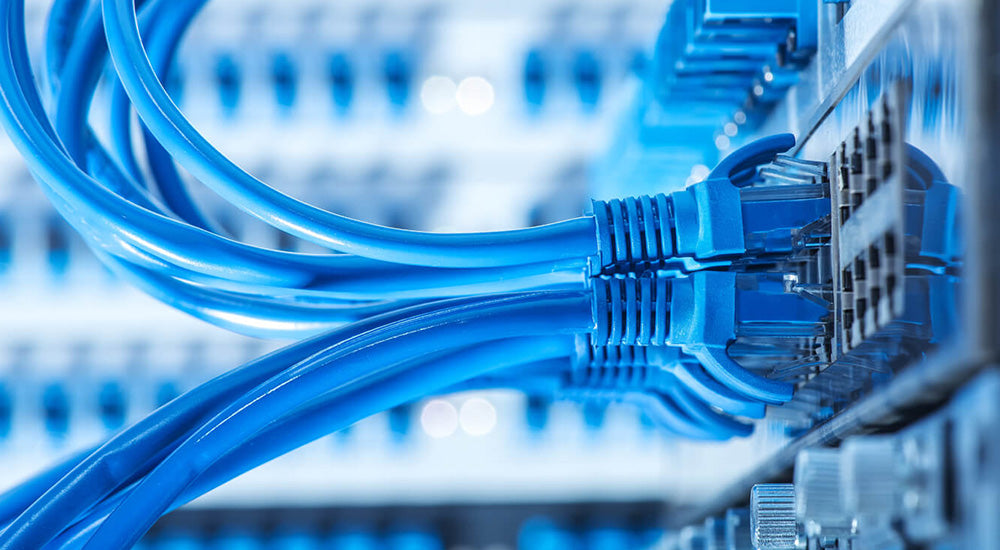 RJ45 Ethernet cables plugged into the ports of an industrial switch